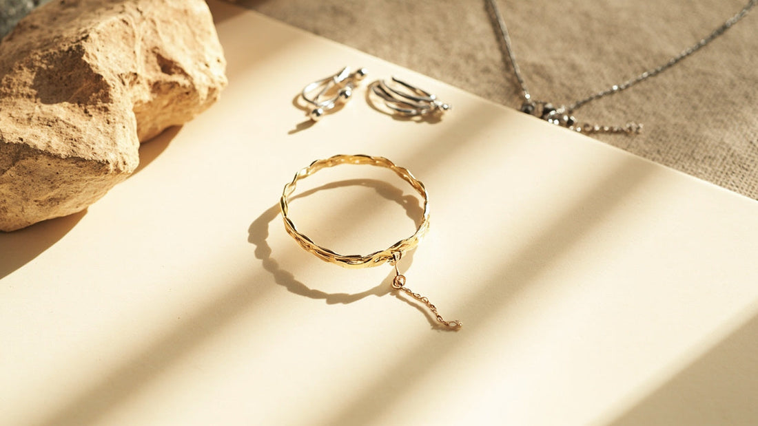 minimalist flat lay of bracelet earrings and necklace in soft morning light