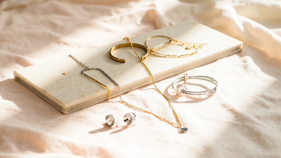 minimalist jewelry set on stone tray with soft natural window light