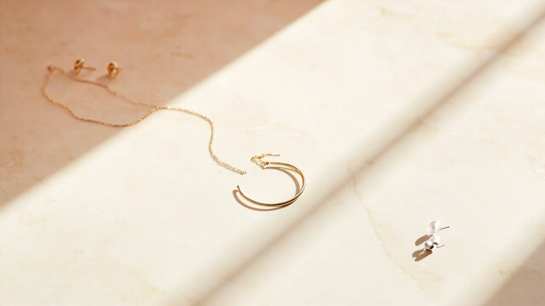 minimalist jewelry flat lay with bracelet earrings and necklace in soft light