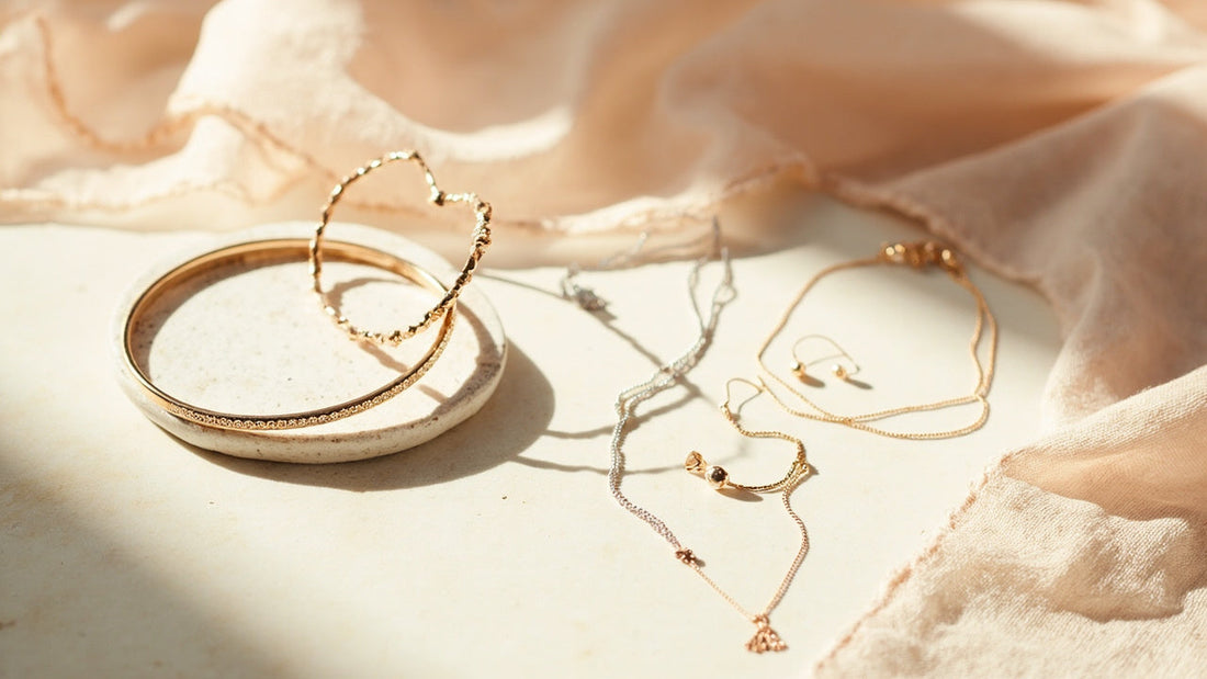 minimalist jewelry set on pale stone with soft morning window light