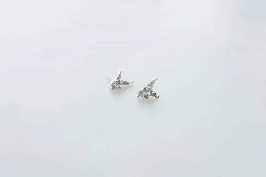 Guardian angel stud earrings with crystal details on a white background